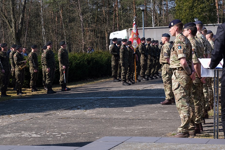 Armed Forces in parade, with flags.